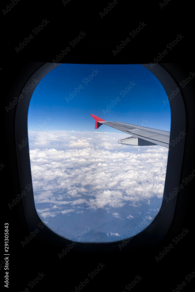 Wing of an airplane flying above beautiful cloud Wing of an airplane flying above beautiful cloud