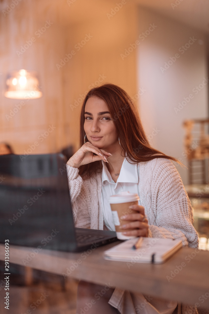 Woman working by laptop in cafe Woman working by laptop in cafe