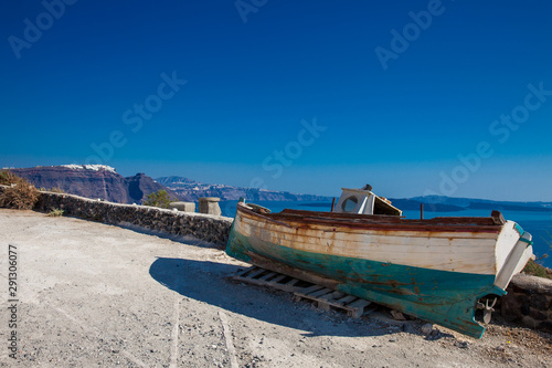 Old boat on the top of a cliff in Santorini Island in a beautiful early spring day