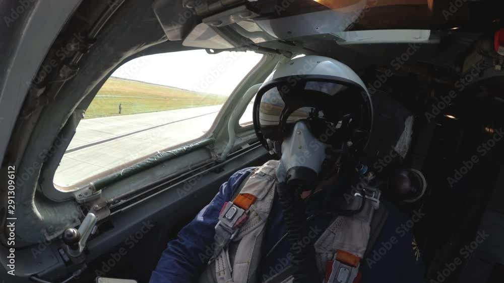 Pilot in a helmet in the cockpit Pilot in a helmet in the cockpit
