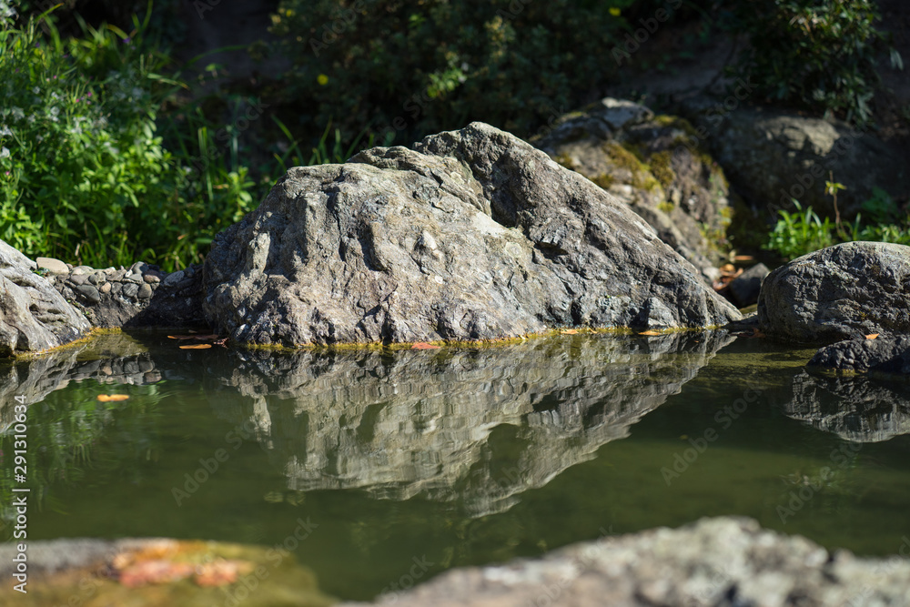 Rocks in a creek reflected in the water. Rocks in a creek reflected in the water.