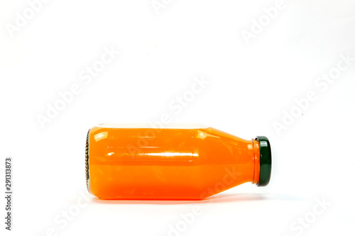 Orange juice in glass bottle Isolated on a white background.