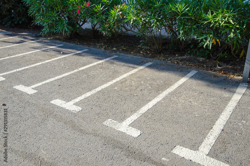 Obraz premium Public motorbike parking areas marked with white lines on the asphalt.