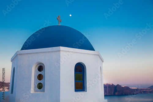 Traditional dome of the churches at Oia City and the moon in Santorini Island