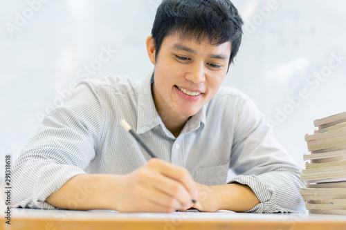 Obraz na plátně close up high school student man hand writing by mark  choices on answer sheet p
