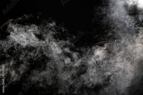 White wispy smoke on black background