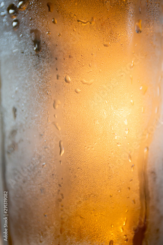 Condensation on glass of amber colored liquid