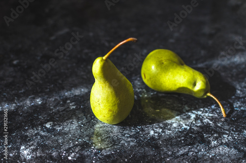 Two pears casting a shadow