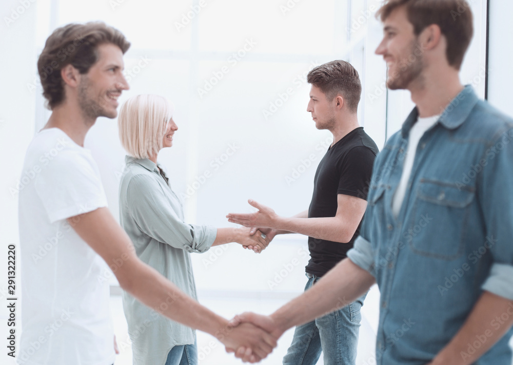 coworkers shaking hands in the office lobby. coworkers shaking hands in the office lobby.