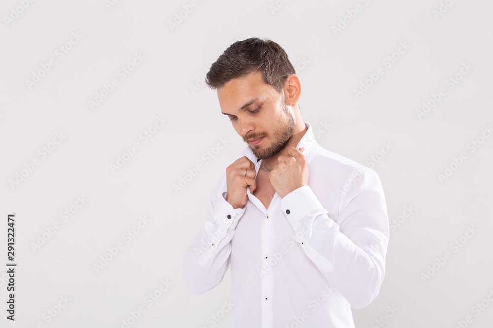 Portrait of handsome happy young man in casual shirt standing against white background with copy space Portrait of handsome happy young man in casual shirt standing against white background with copy space