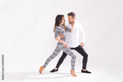 Social dance, kizomba, tango, salsa, people concept - beautiful couple dancing bachata on white background with copy space