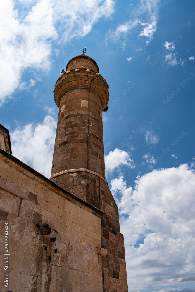 Dogubayazıt, Turkey: view of the minaret of the mosque Eski Bayezid Cami in the breathtaking valley of the famous Ishak Pasha Palace, located on the road up to the mountains near the Iranian border 