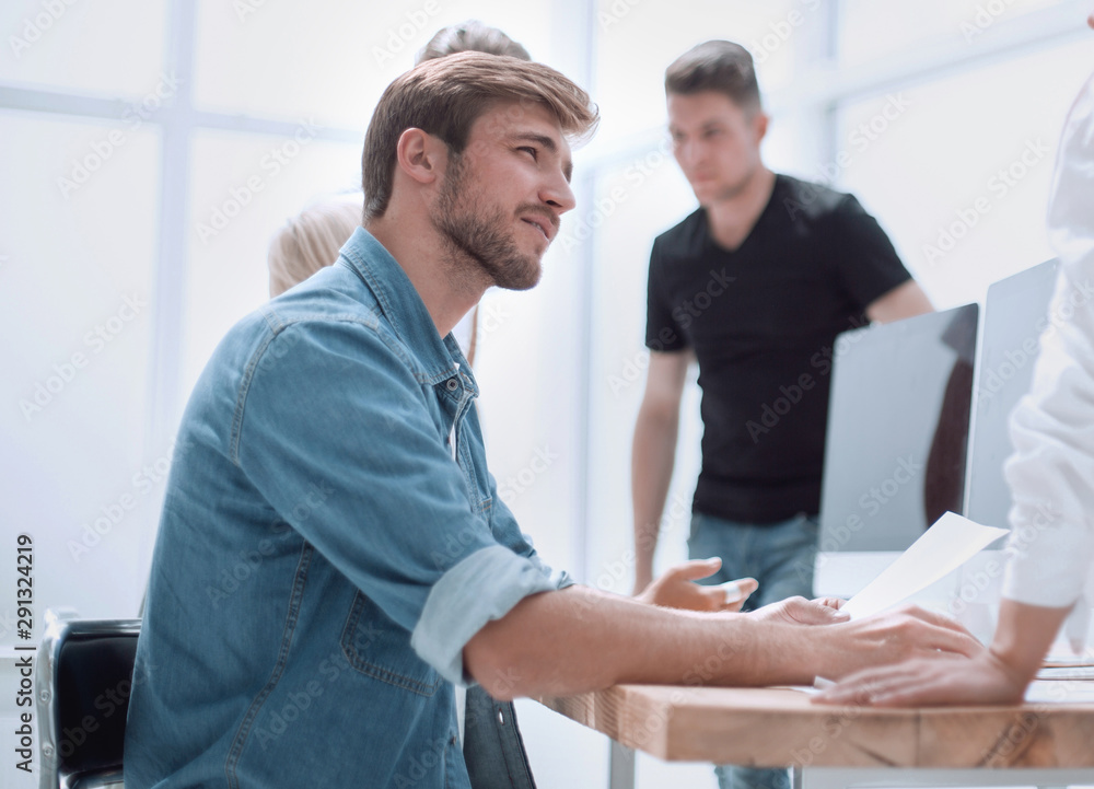colleagues discussing business documents at the workplace colleagues discussing business documents at the workplace