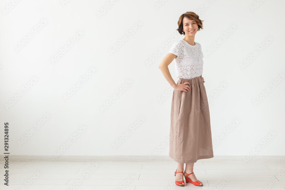people, fashion and style concept - young woman posing in clothes in studio on white background. people, fashion and style concept - young woman posing in clothes in studio on white background.
