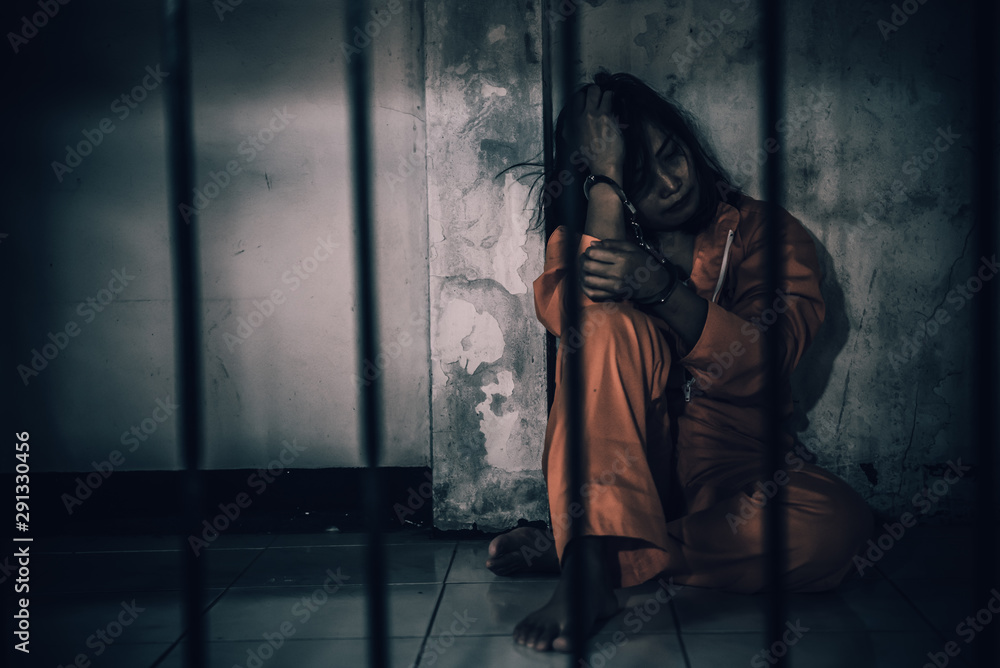 Portrait of women desperate to catch the iron prison,prisoner concept,thailand people,Hope to be free,If the violate the law would be arrested and jailed. Portrait of women desperate to catch the iron prison,prisoner concept,thailand people,Hope to be free,If the violate the law would be arrested and jailed.