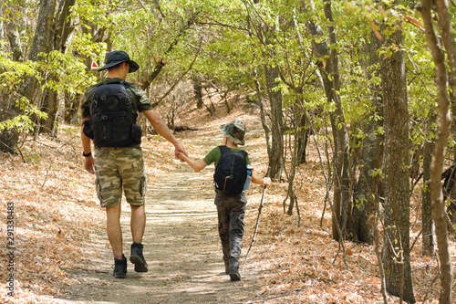 Father and son walking in forest