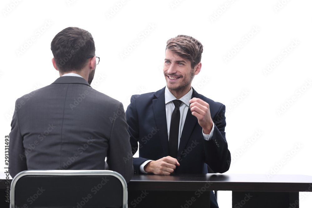 two business people talking sitting at a Desk two business people talking sitting at a Desk
