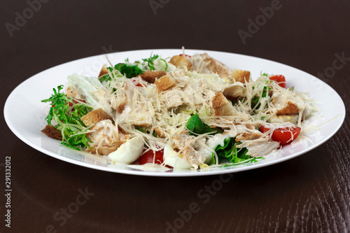 vegetable salad with cheese and chicken in a plate