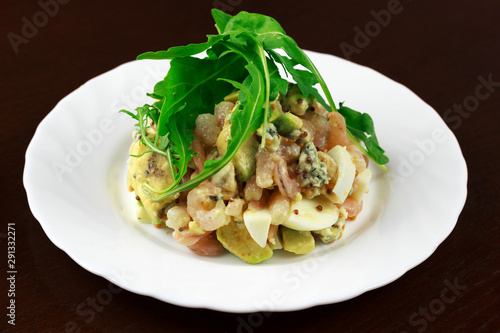  shrimp salad with egg and vegetables in a plate