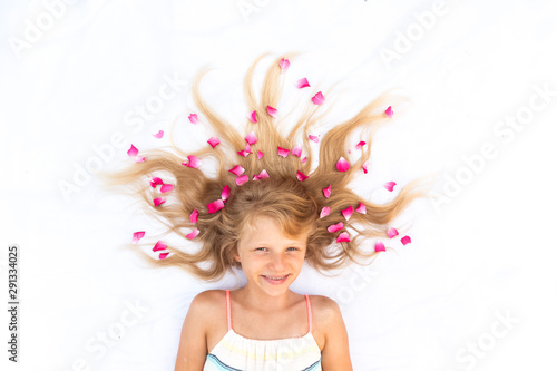 charming smiling young child with floral adornment hairdo copy space