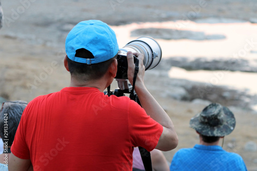 Photographer at the waterhole - Namibia Africa