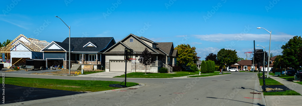 Panorama of a suburban street with new house construction