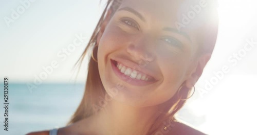 Wallpaper Mural Slow motion of young smiling brunette woman is happy to enjoy a summer vacation on a beach with a sea in a sunny day. Torontodigital.ca