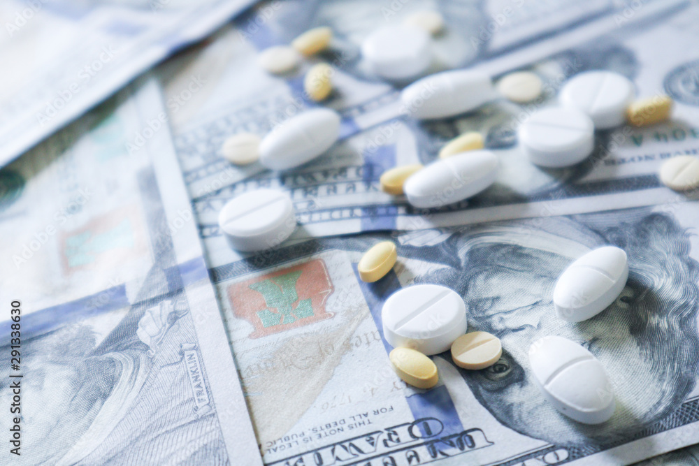 medicine pill on 100 dollar banknote background.Healthcare insurance and medical treatment cost concept medicine pill on 100 dollar banknote background.Healthcare insurance and medical treatment cost concept
