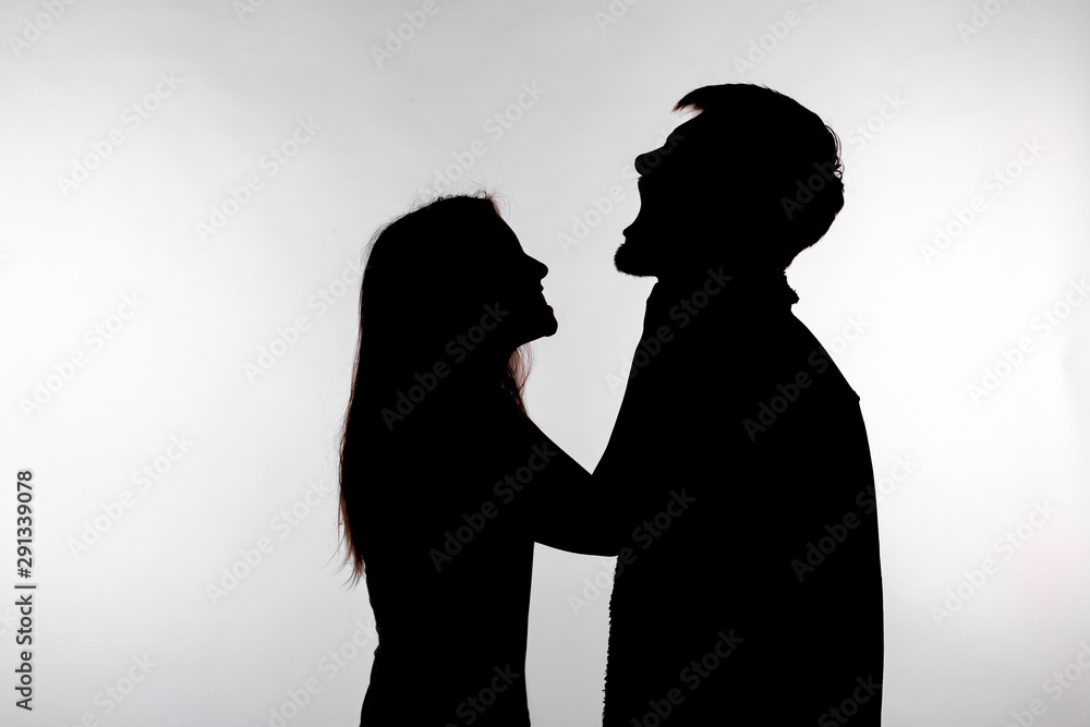 Domestic violence and abuse concept - Silhouette of a woman asphyxiating a man