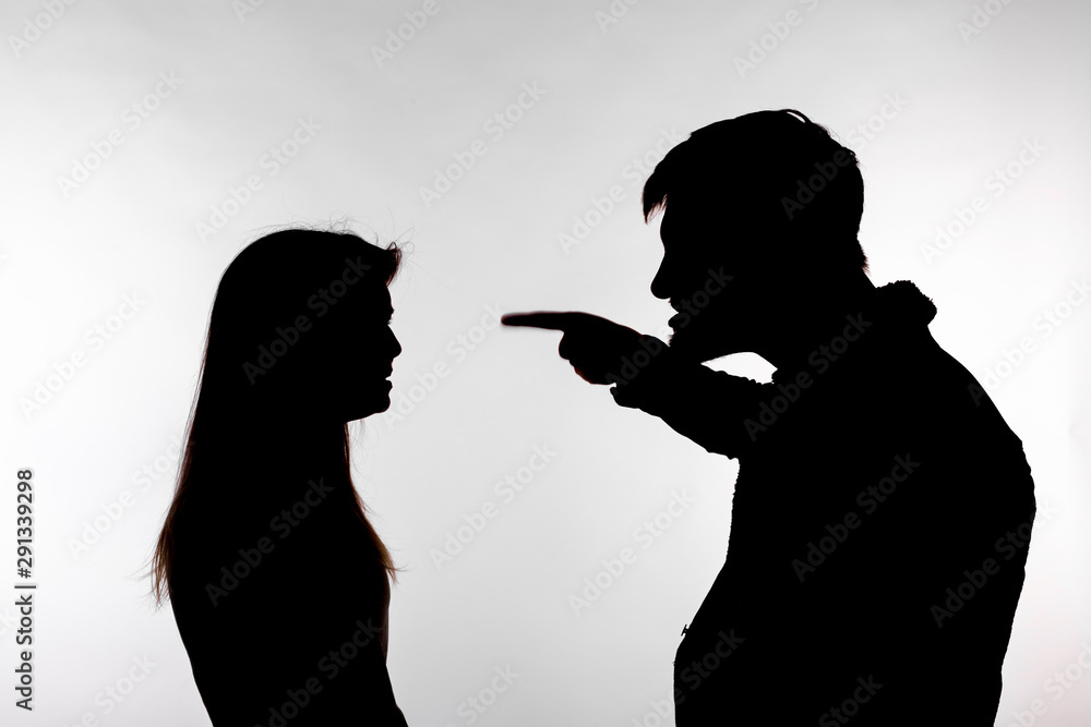 Aggression and abuse concept - man and woman expressing domestic violence in studio silhouette isolated on white background.