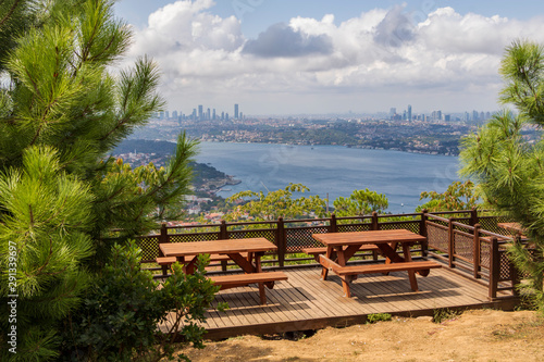 View of Istanbul from Karlitepe, Beykoz. Picnic tables in the park. Bosporus and cloudy sky. Istanbul, Turkey photo