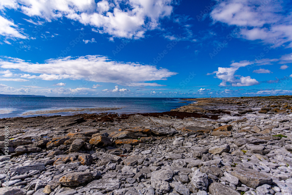 View of the empty limestone rocky beach of the island of Inis Oirr with the Atlantic Ocean in the background on a wonderful day, Inisheer is a small island in the west of the coast of Ireland.
