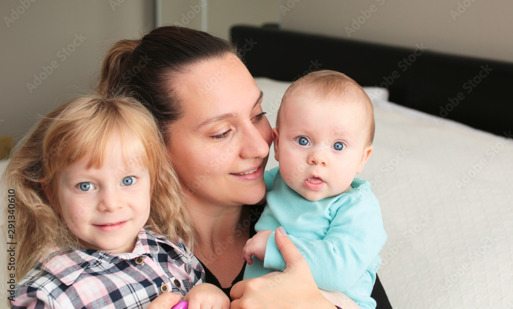 Close up portrait of Young Beautiful Mother with two daughters, Cute 6 Month Old Baby Girl , 7 Years Old Girl, Happy Family, Happy Mother’s Day, Best Mother Concept, The Most Beautiful Girls in the wo Close up portrait of Young Beautiful Mother with two daughters, Cute 6 Month Old Baby Girl , 7 Years Old Girl, Happy Family, Happy Mother’s Day, Best Mother Concept, The Most Beautiful Girls in the wo