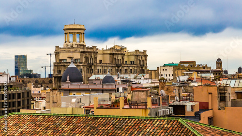 Roofs of houses and buildings in a part of the city of Barcelona, ​​wonderful cloudy day clouds to enjoy and sightsee the city in Spain