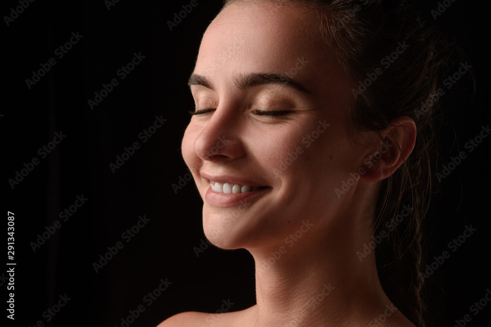 portrait of a young beautiful brunette girl on a black background portrait of a young beautiful brunette girl on a black background
