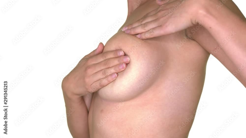 Profile shot of woman checking for lumps in breast cancer screening shot in studio white background Profile shot of woman checking for lumps in breast cancer screening shot in studio white background