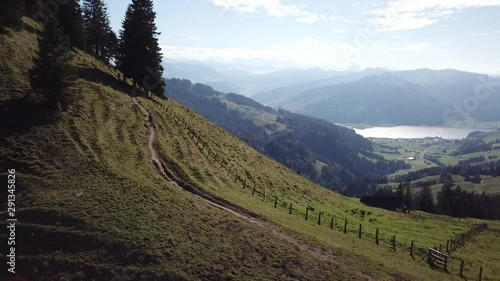 Traveller walking uphill at Sattelegg Pass with Sihlsee lake background Switzerland photo