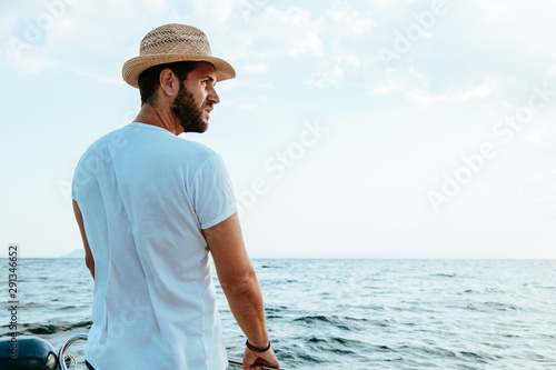 Young man enjoying a view of the sea from the boat