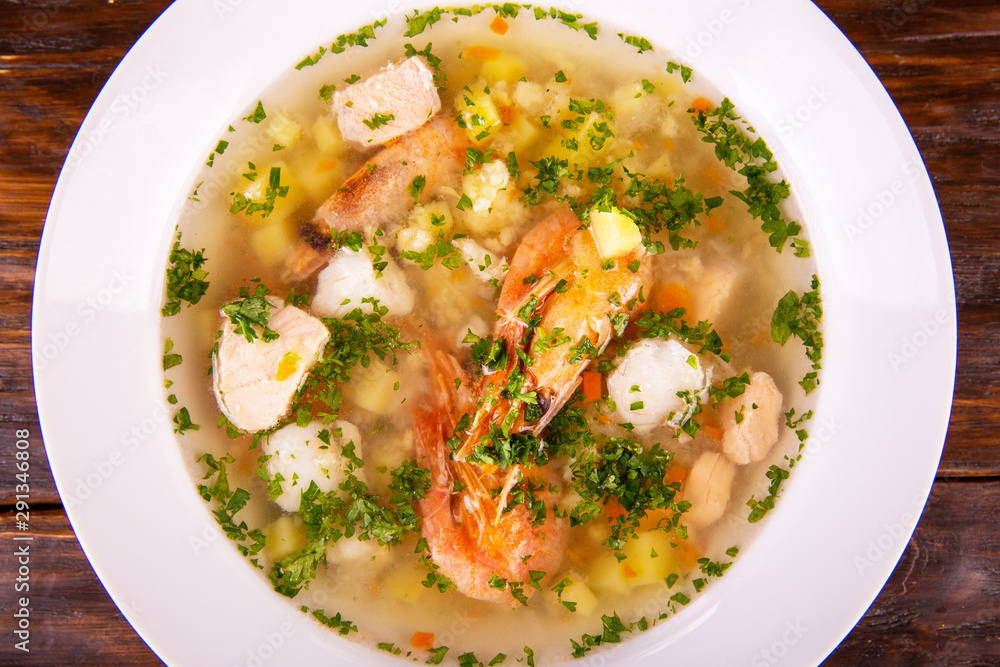 Shrimps soup and pieces of fish and fresh greens Shrimps soup and pieces of fish and fresh greens