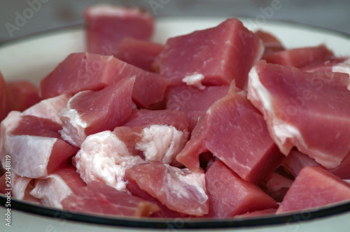 Raw meat cut into large pieces, photographed close-up