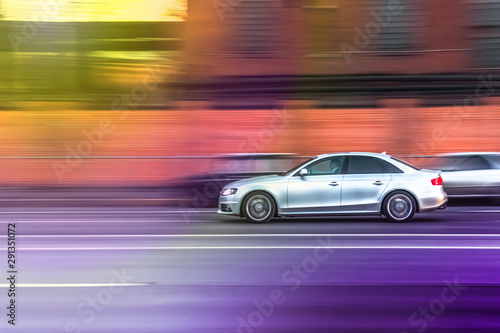 the car drives  fast along a city street, overtakes other vehicles, blurred focus © Leka