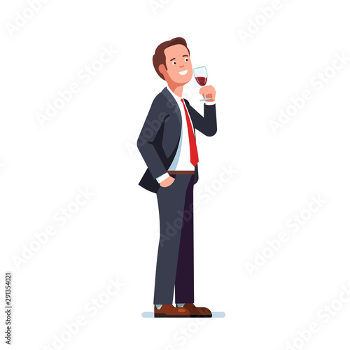 Man in business suit drinking red wine in a glass