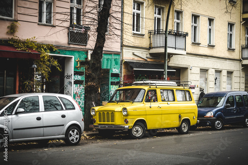 Vintage yellow van on the street in Berlin in autumn. Travel van concept. Travel and tourism in Berlin. © Oleksandr