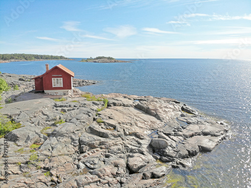 Red traditional cottage in the swedish archipelago a sunny summer day