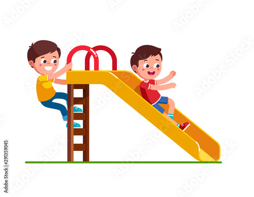 Boy sliding down slide and climbing up ladder
