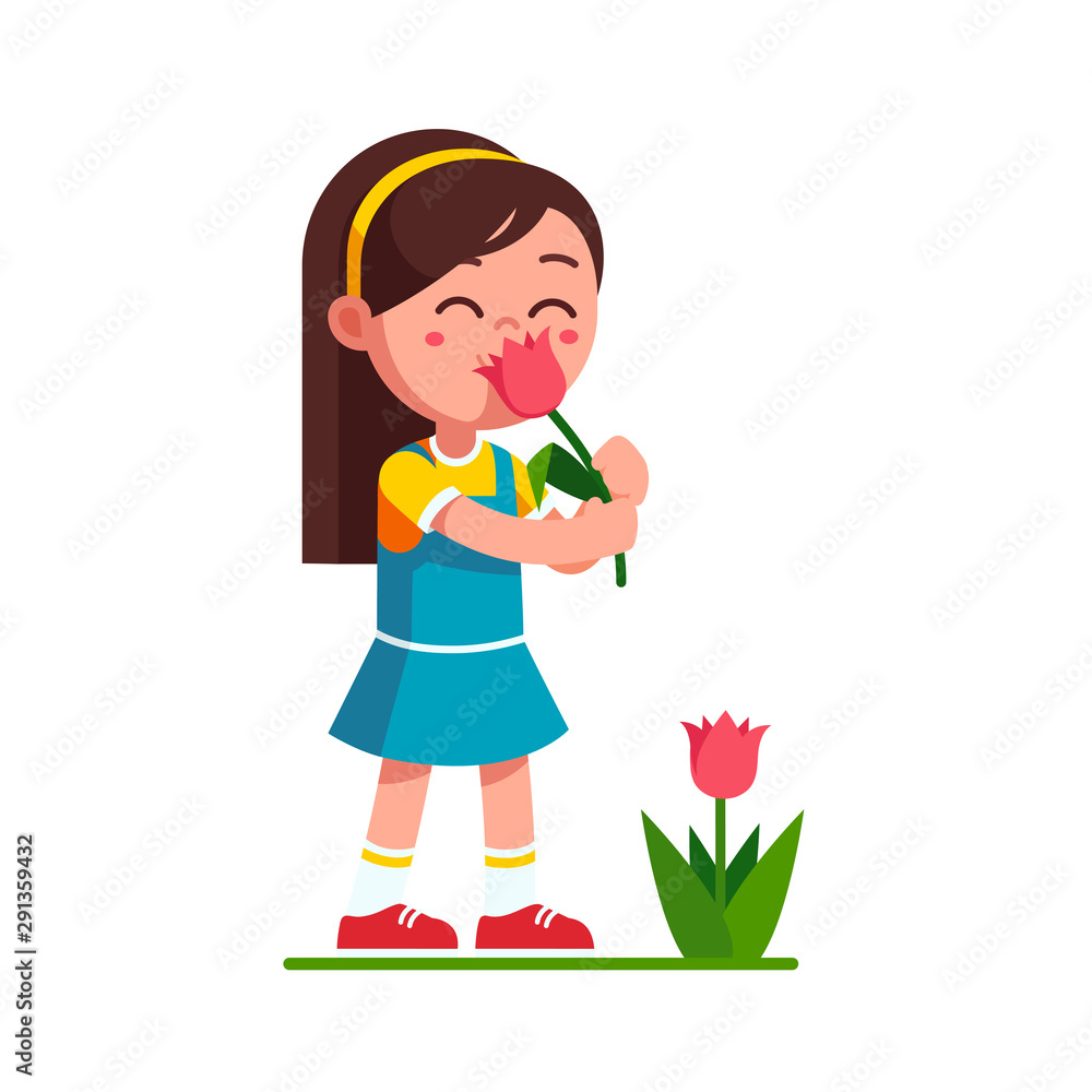 Girl kid holding tulip flower and smelling it Girl kid holding tulip flower and smelling it