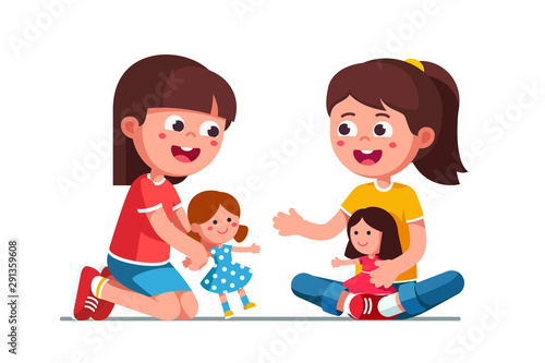 Happy smiling girls kids playing with dolls