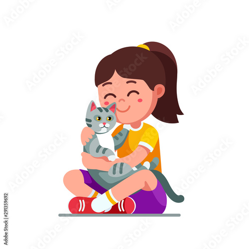 Happy preschool girl kid embracing and patting cat