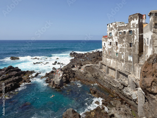 wild Atlantic Ocean in Tenerife with houses directly on the lava cliff