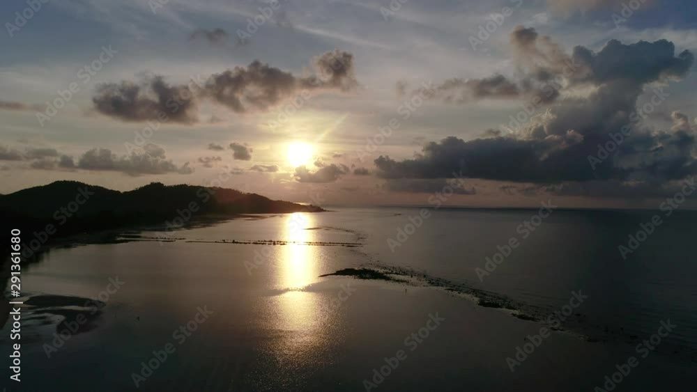 Aerial photo of sunrise over the ocean on a tropical island Aerial photo of sunrise over the ocean on a tropical island